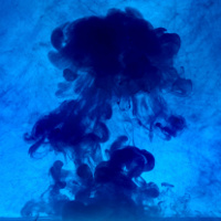 Dark sepia ink cloud dispersing in seawater as a cuttlefish ejects it as a defense